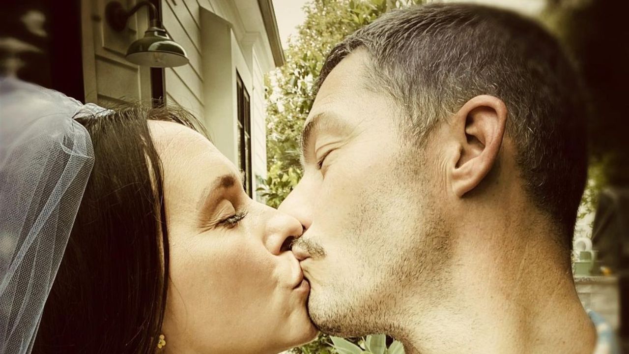 Jennifer Love Hewitt and her husband Brian Hallisay kissing. weightandskin.com